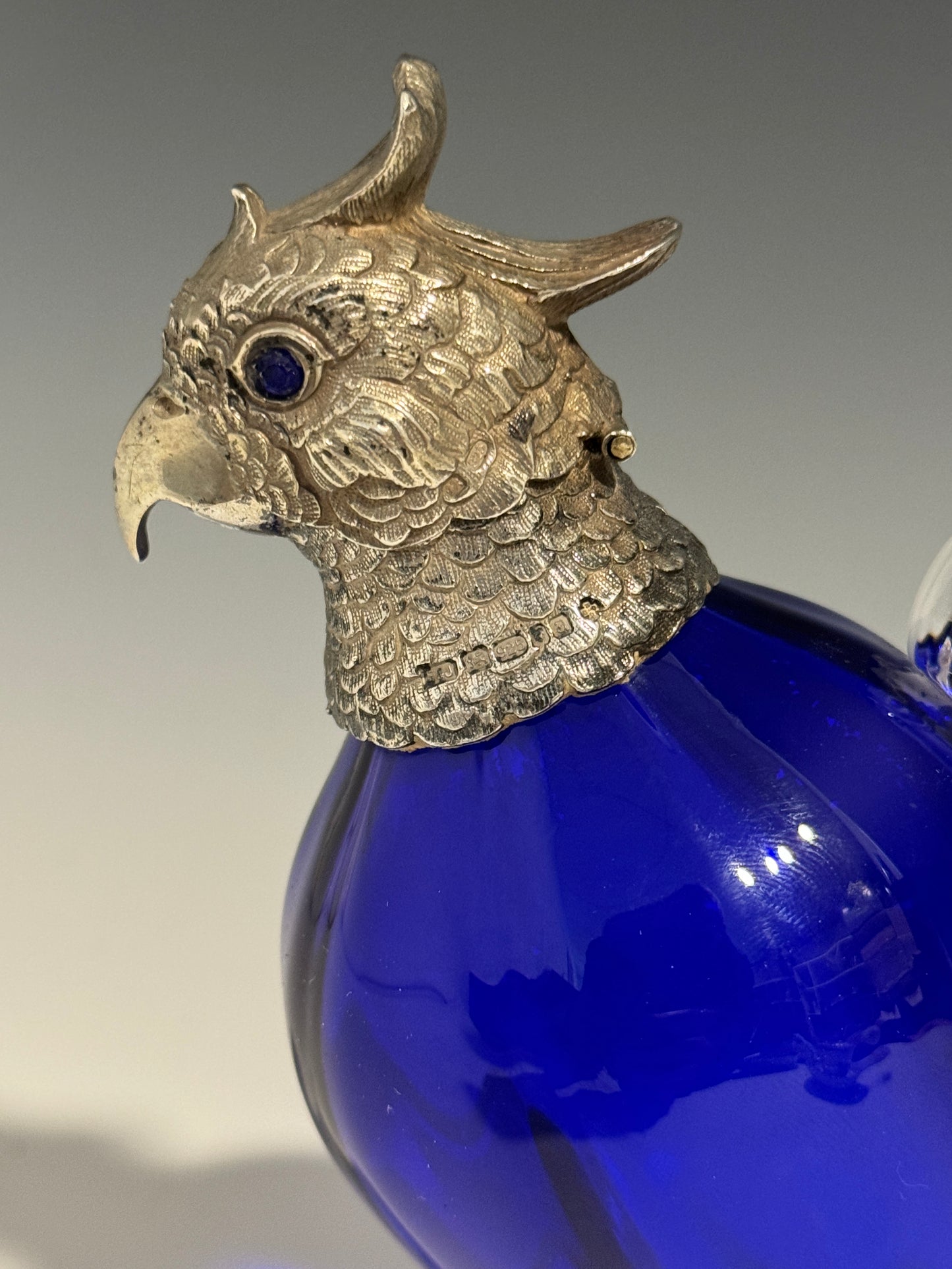 A Bristol Blue Glass and Hallmarked Silver Cockatoo Parrot Claret Jug