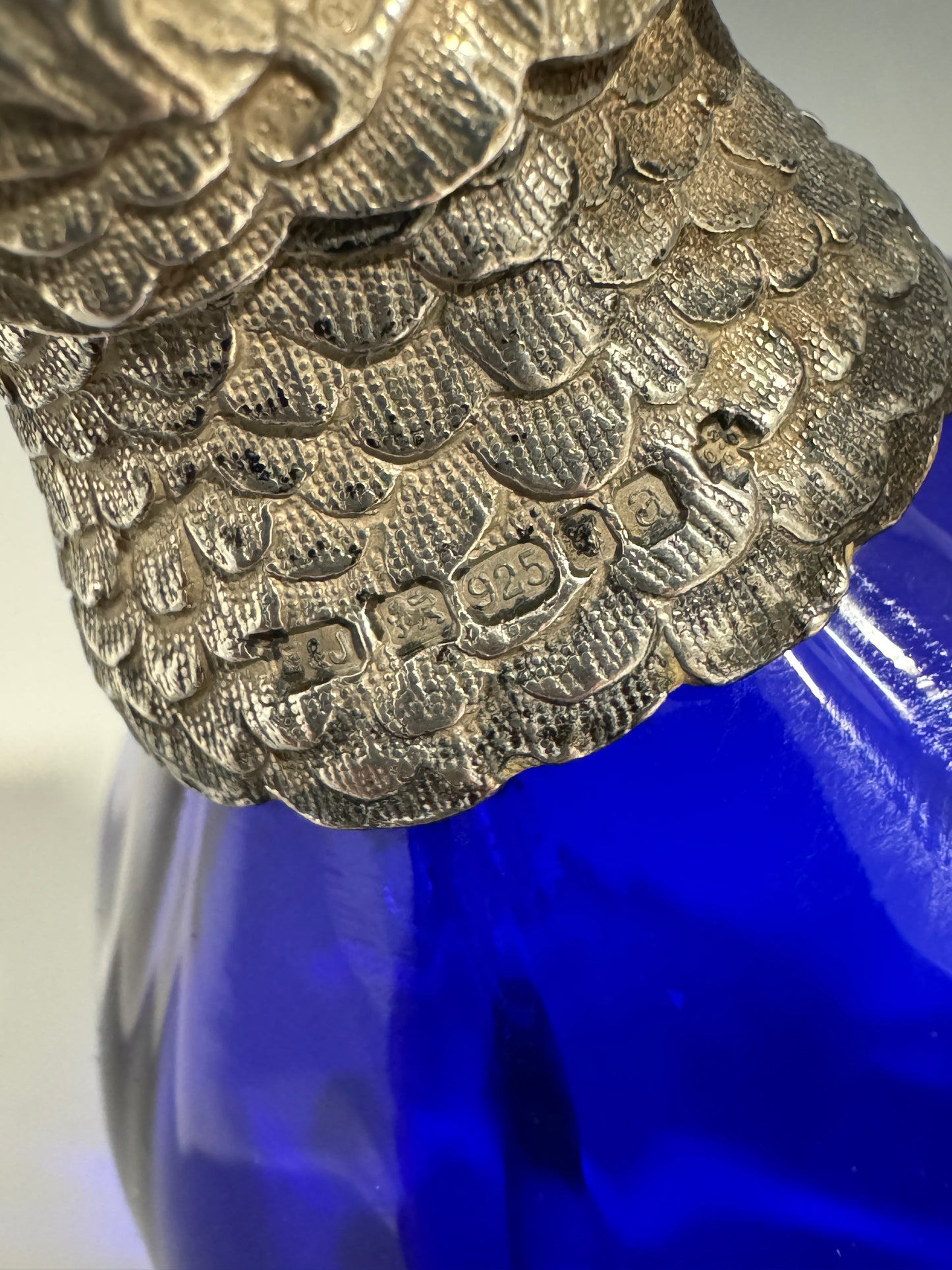 A Bristol Blue Glass and Hallmarked Silver Cockatoo Parrot Claret Jug