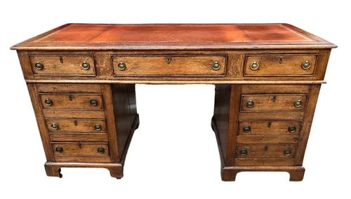 A late 19th century oak twin pedestal desk